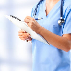 Healthcare worker reviewing chart, representing concerns over patient care and workplace safety disclosure