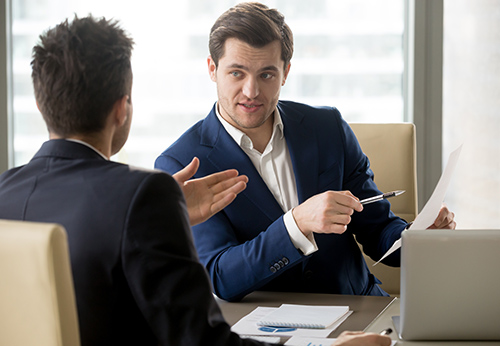 Financial executive consulting lawyer about a contract dispute or wrongful termination on Wall Street															